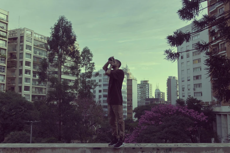 a man is standing on the edge of a cement wall