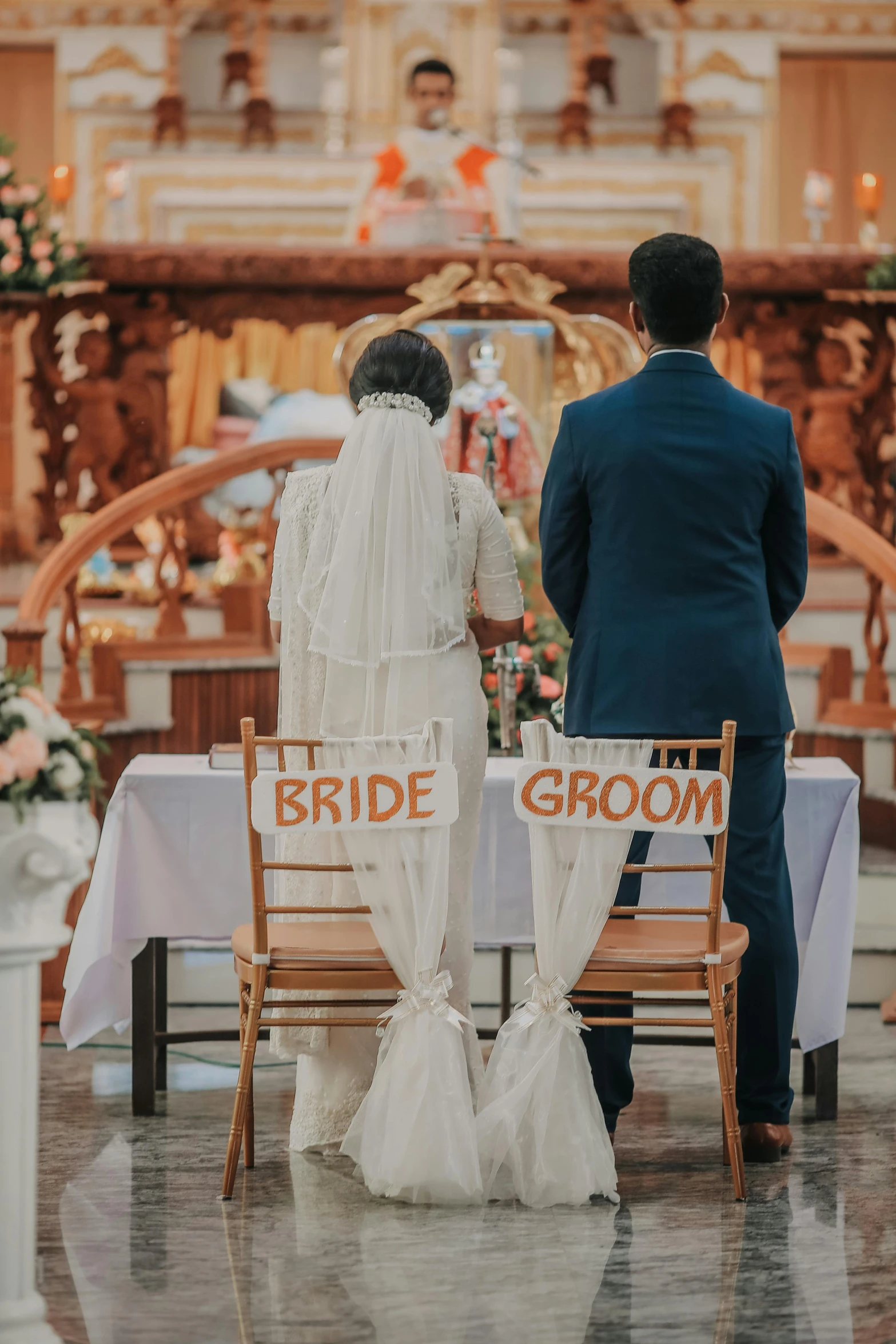 the bride and groom standing next to each other at the alter