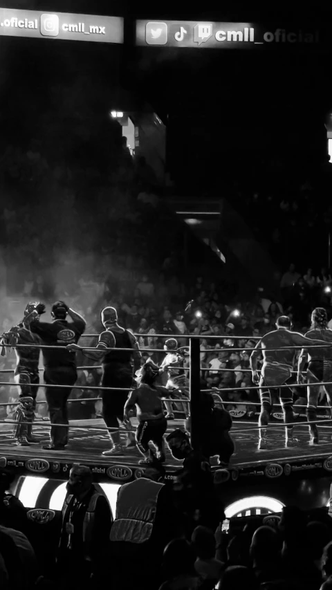 two men on top of one another in the ring with boxing gloves