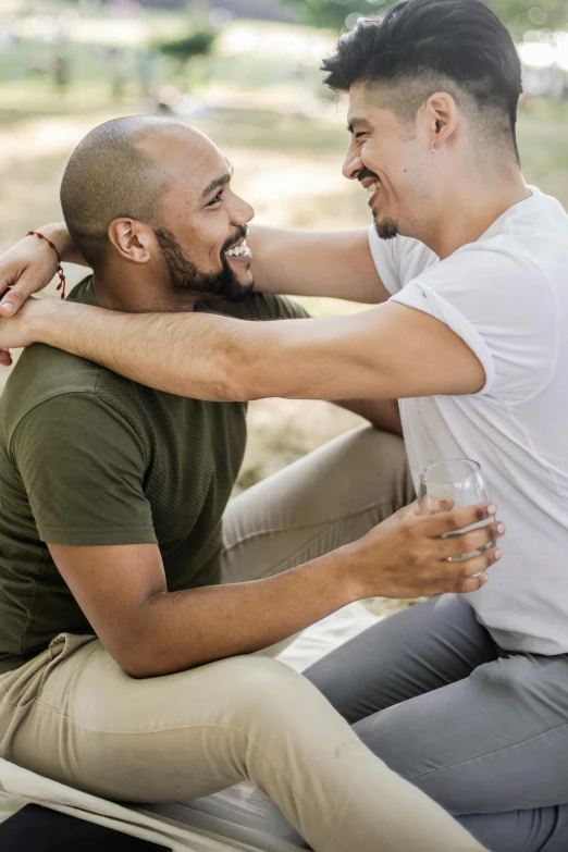 two men sitting on the ground having fun