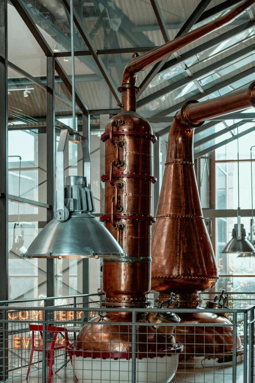 industrial style copper flasks, metal lamps and copper pipes in the factory