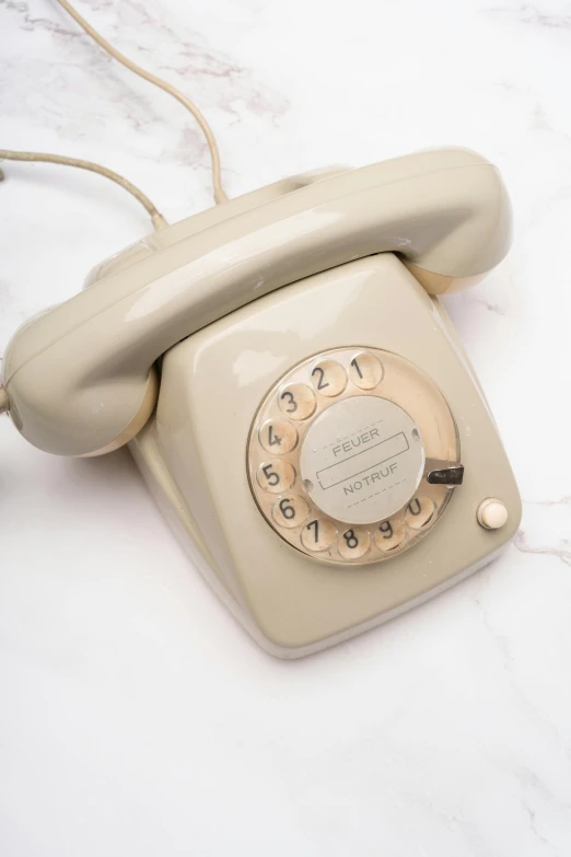 an old style phone on a marble surface