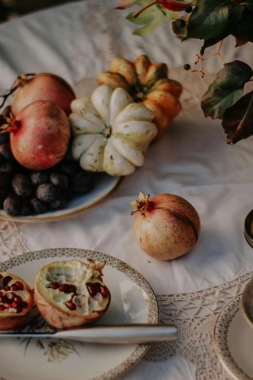 three plates with fruit on them and some other food on a table