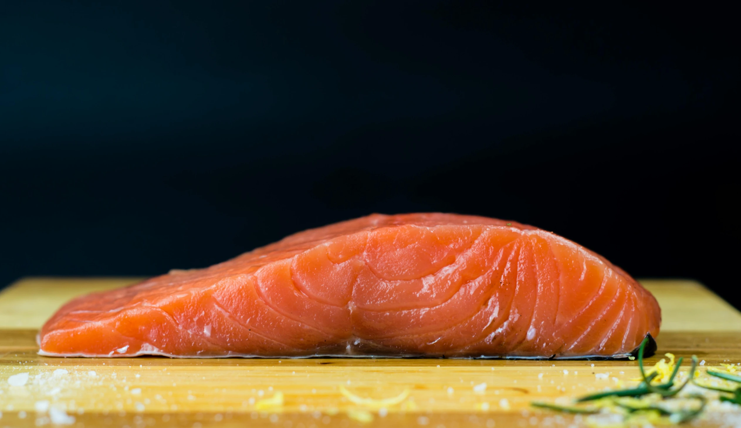 a close up of a salmon on a  board