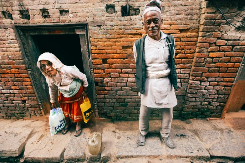 an elderly man and woman standing next to each other