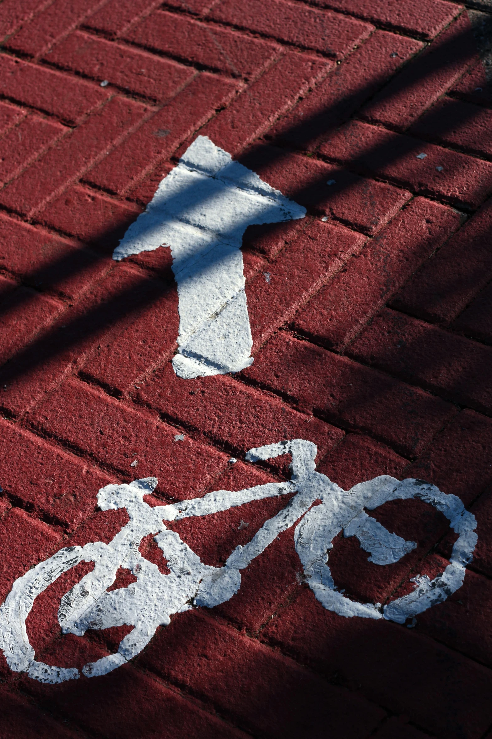 a bicycle drawn on the sidewalk in red chalk