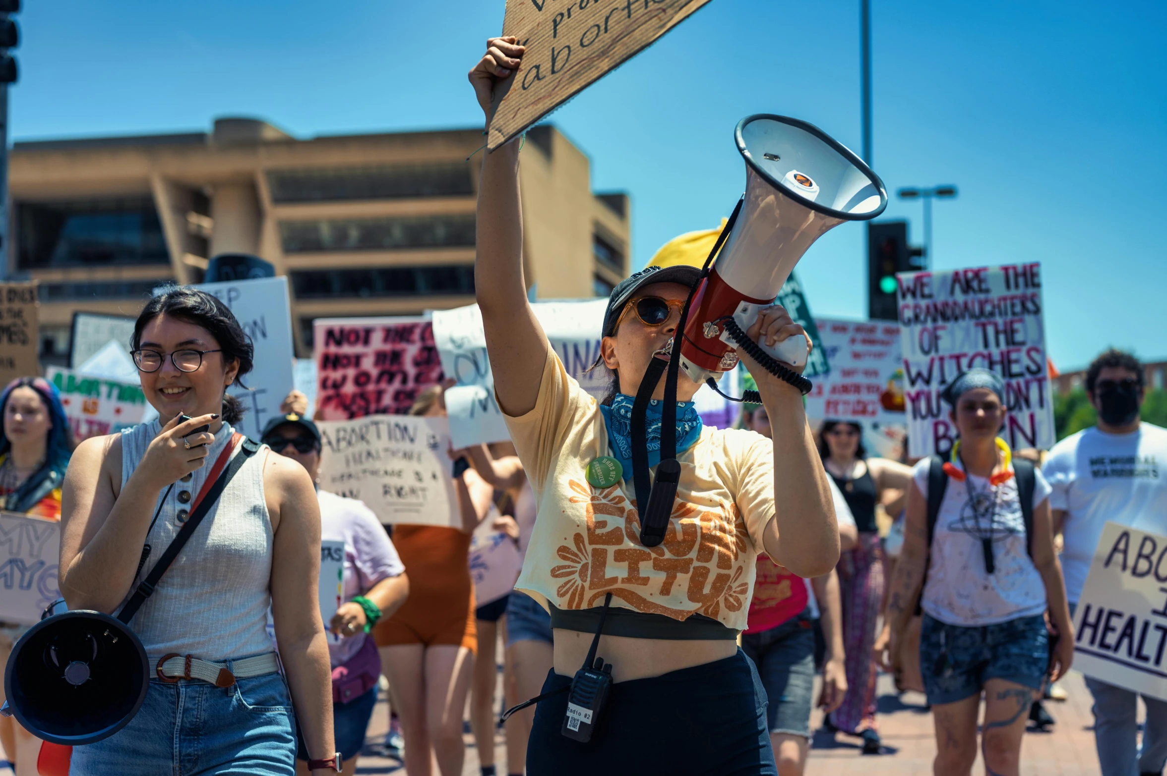 some women are marching with signs and a bullhorn