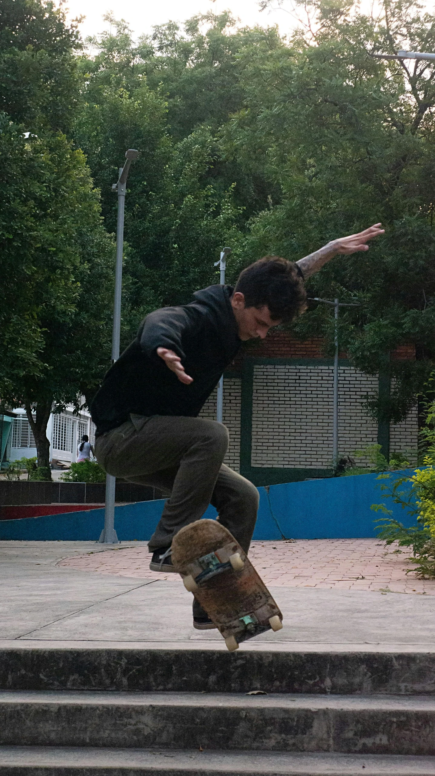 the man is in the air while doing a trick on his skateboard