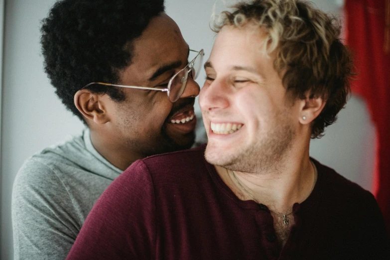 two men are smiling and sharing a laugh