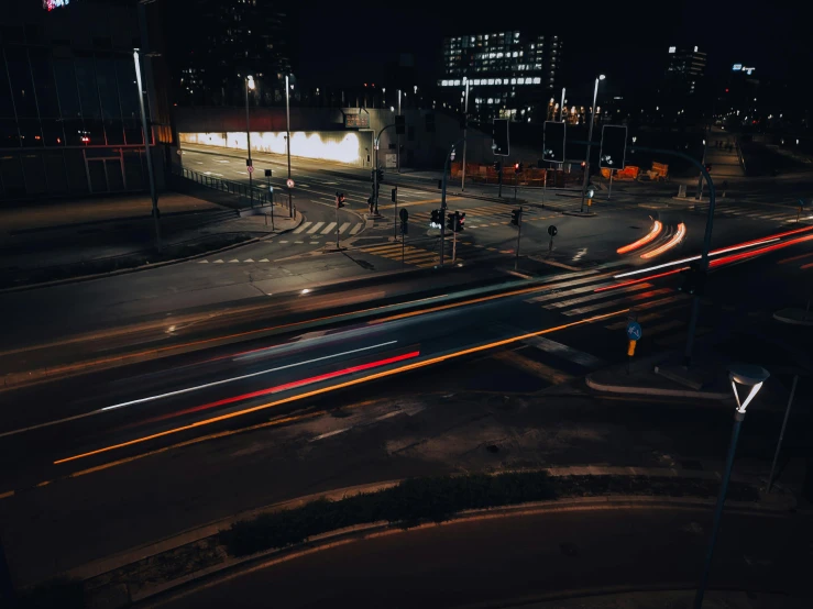 street lights streak down on an intersection in the city