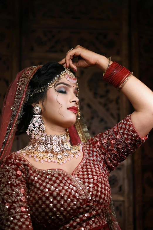 a women is dressed up with a jewelry set on her head