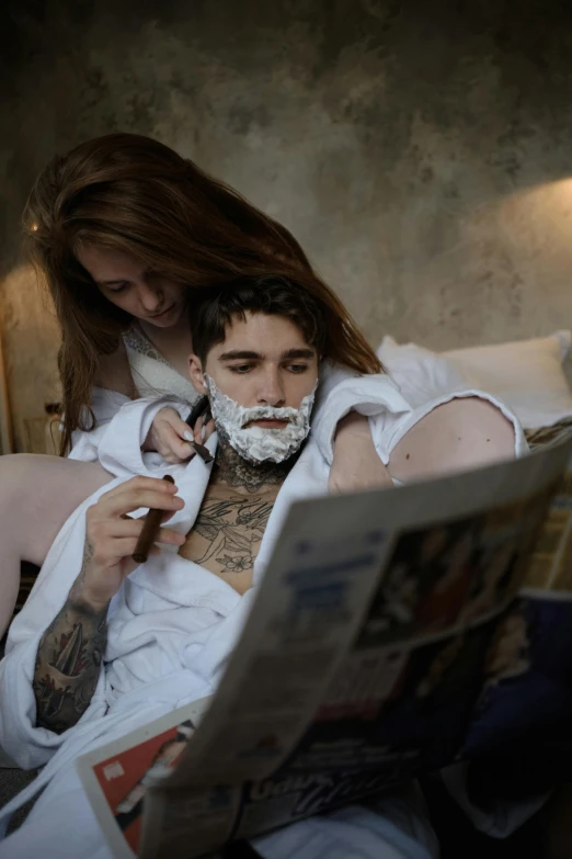 woman and man laying next to each other with a tattoo on their chest