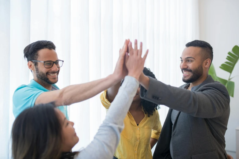 a group of people reaching their hands together