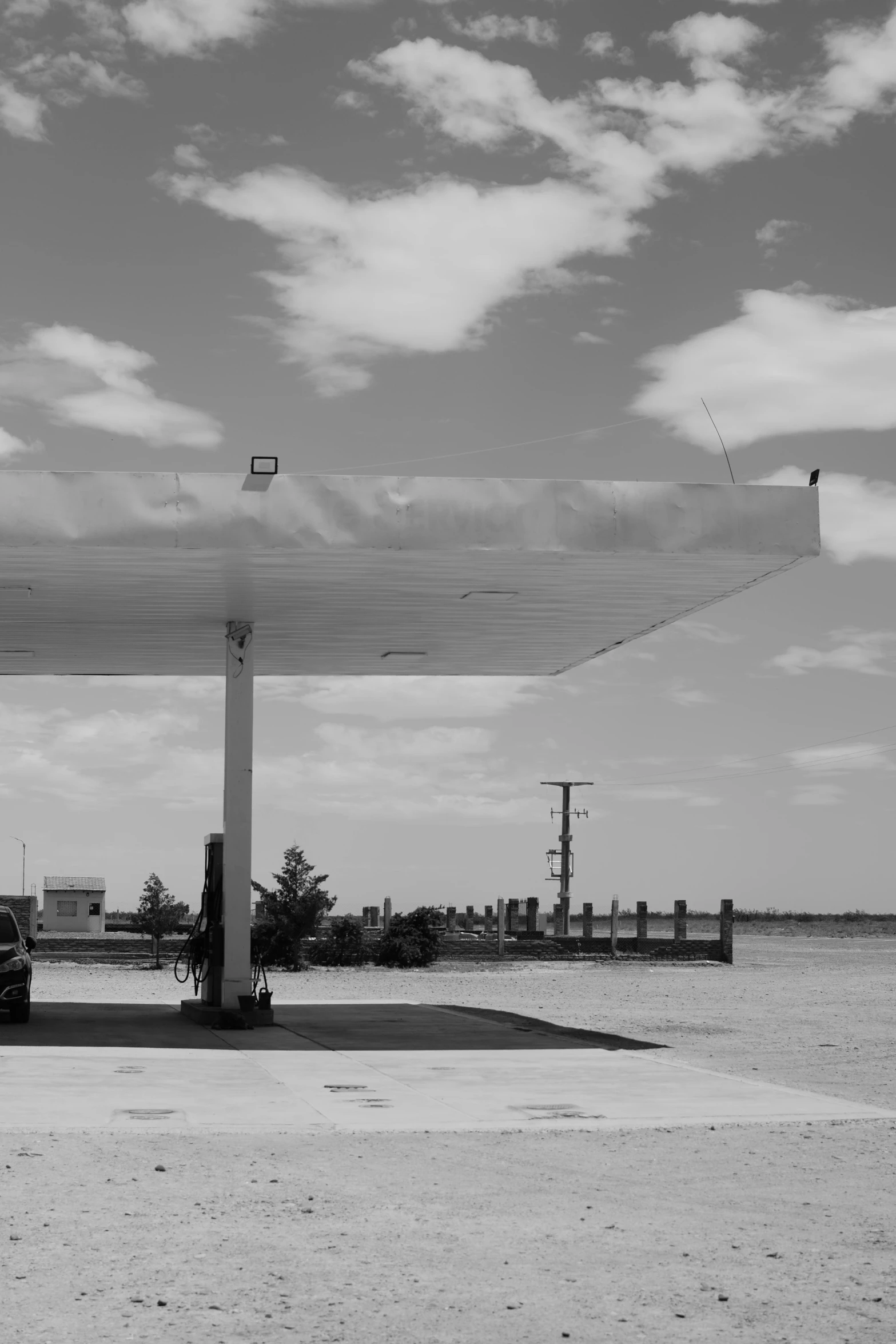 a parking lot with cars parked under a large covered structure