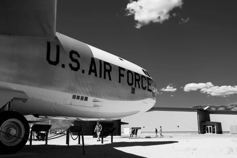 black and white po of a us air force jet parked in front of a hangar