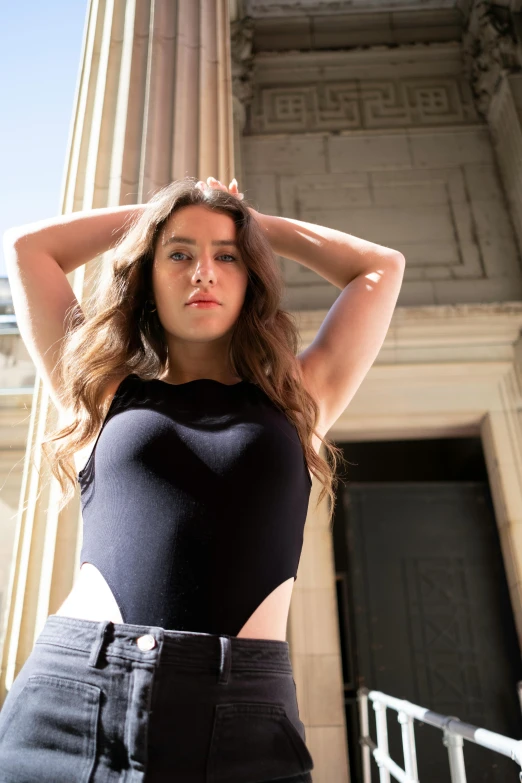 a young woman standing in front of a building posing for the camera