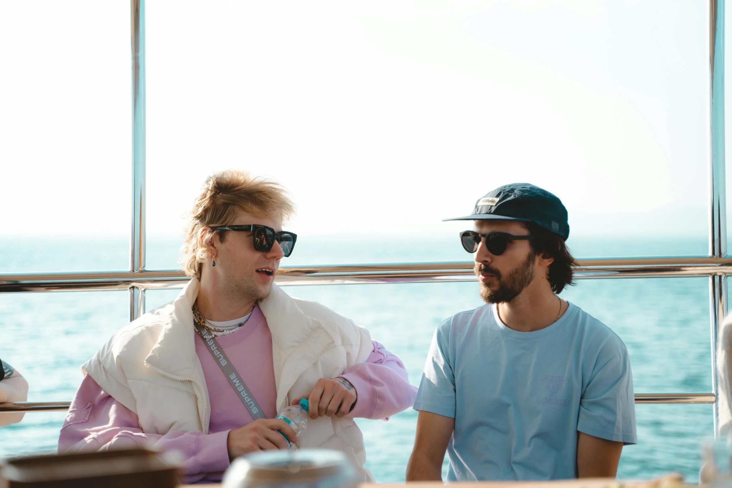 two men sitting on the deck of a boat