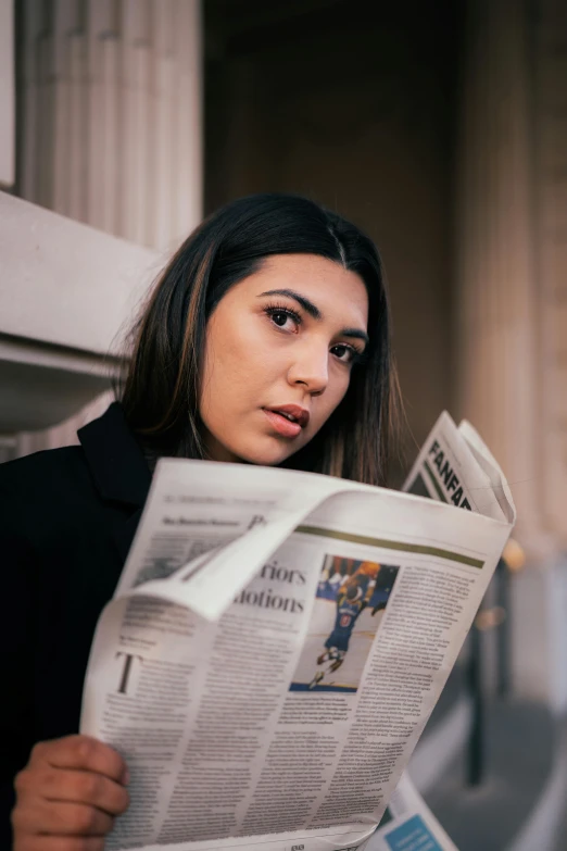 a woman reading the news holding her newspaper