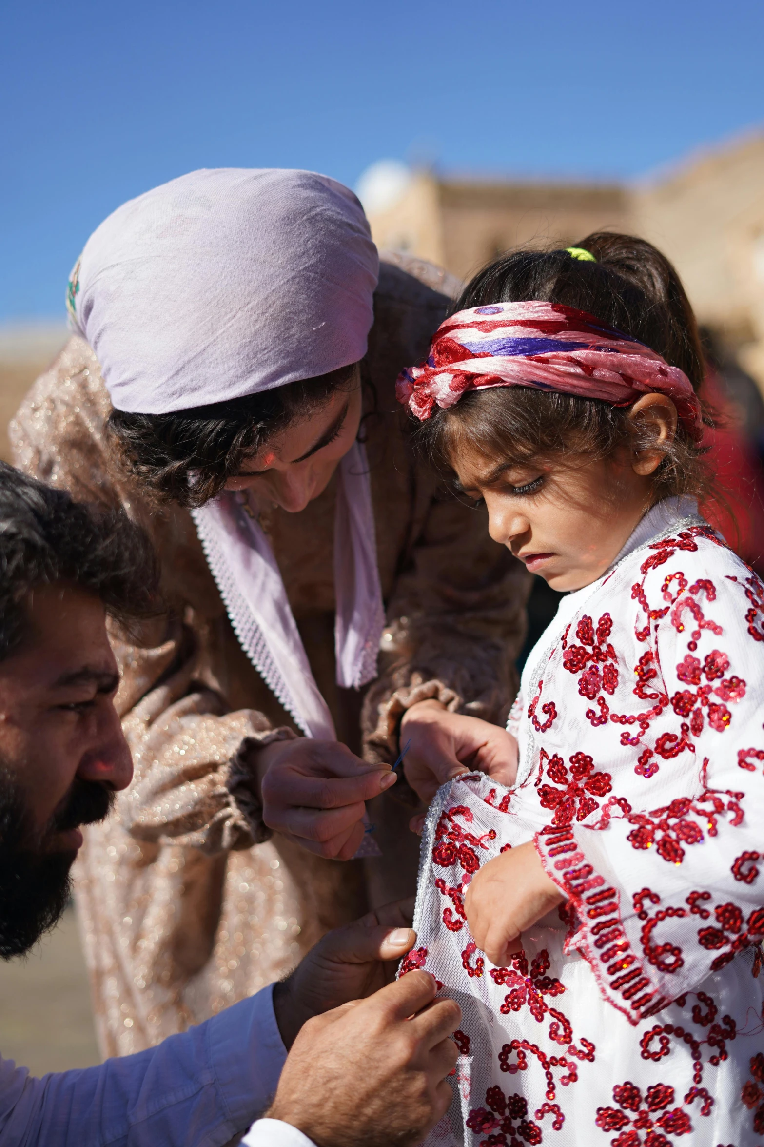 a man holding a little girl and two others