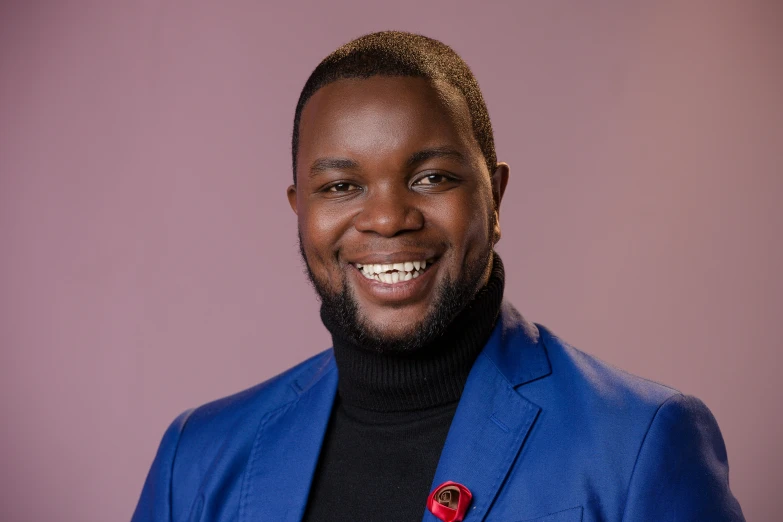 a smiling man with a jacket on