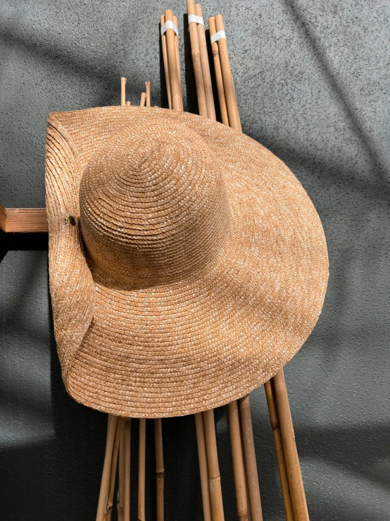 a straw hat sitting on top of a wooden pole