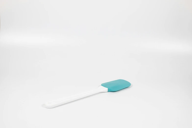 a blue and white toothbrush against a white background