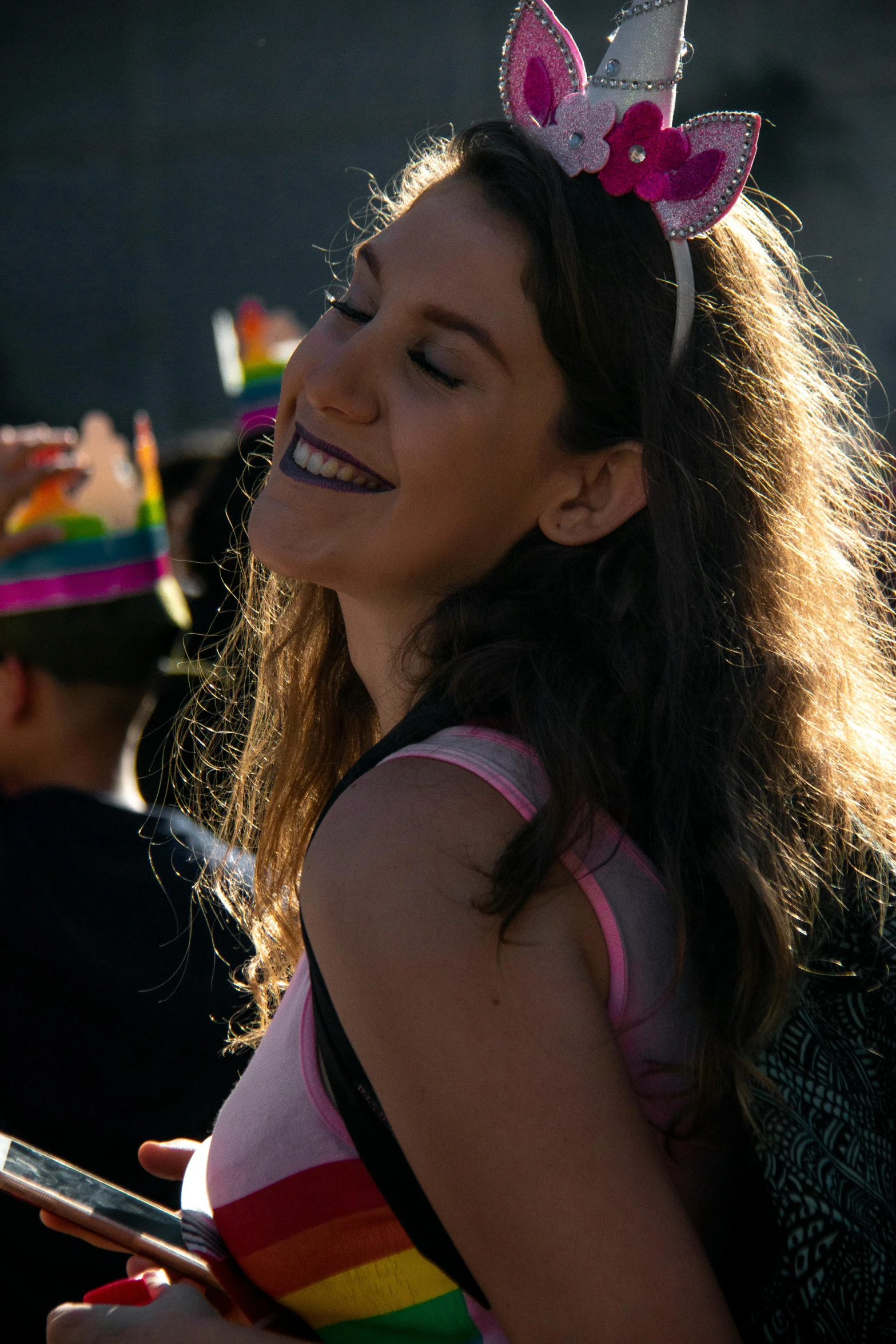 a girl wearing pink and silver is smiling