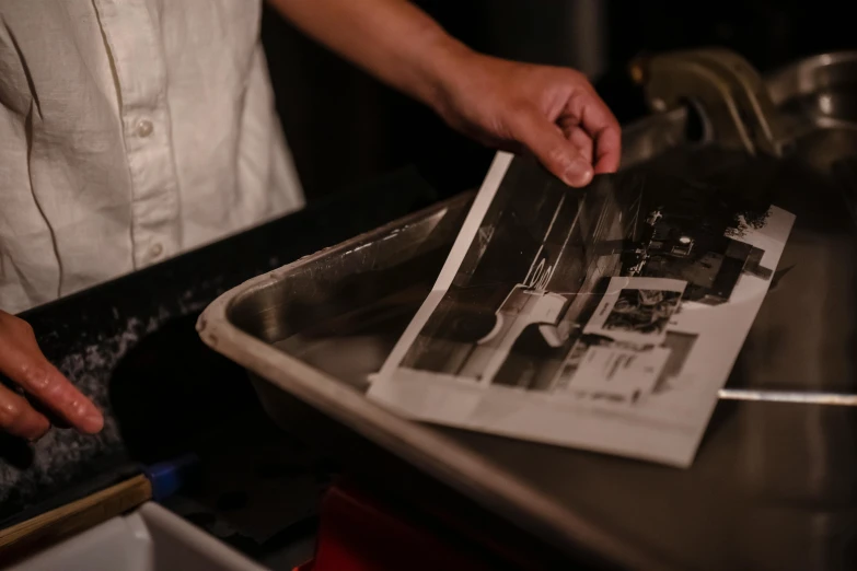 an image of an old po being taken in a kitchen