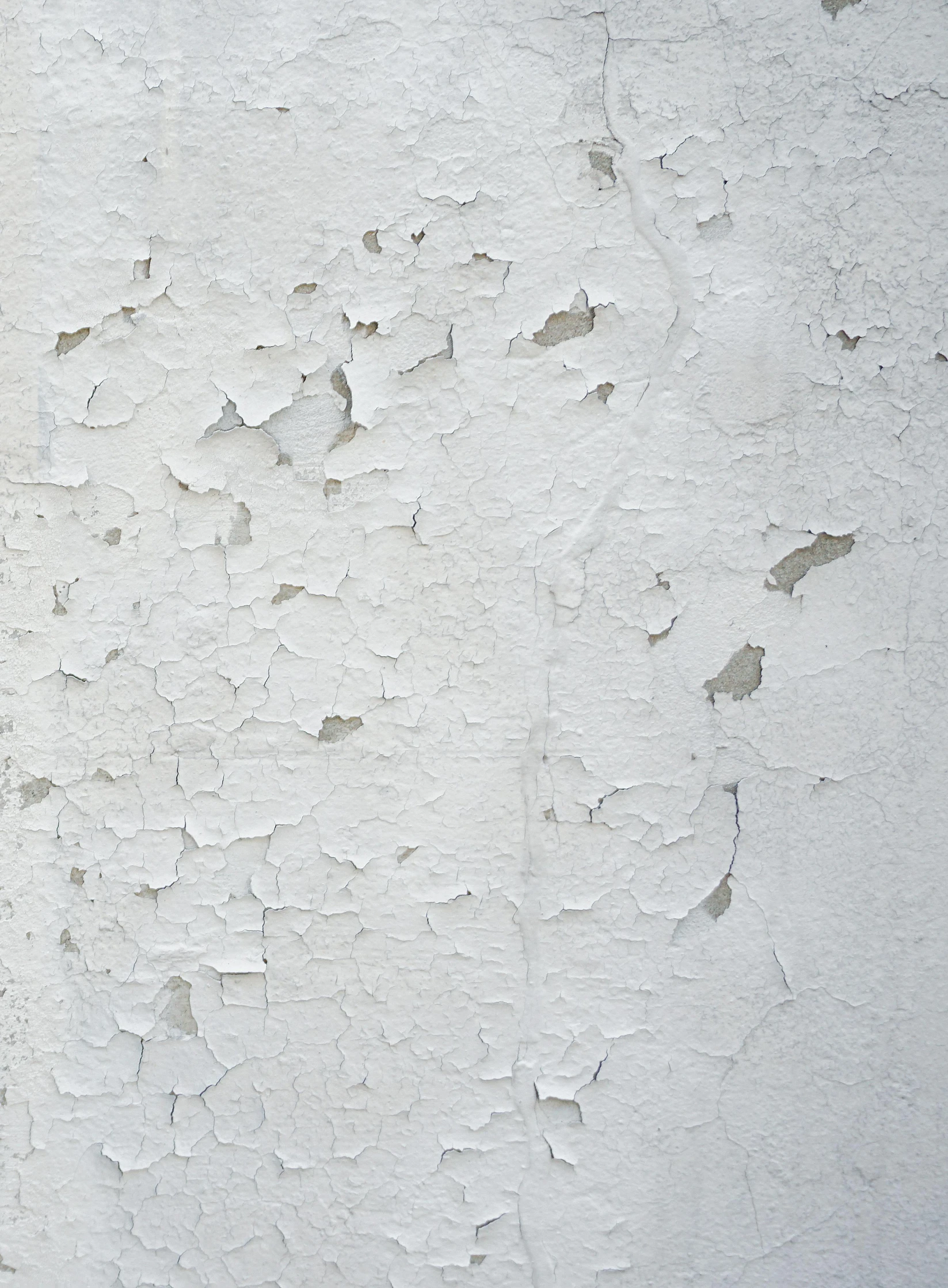 a white paint covered wall with peeling paint