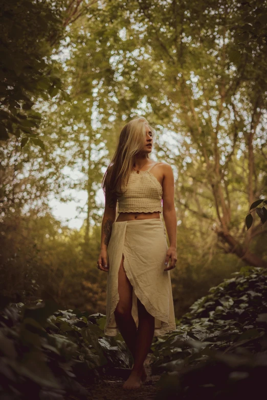 a young woman in a skirt posing outdoors