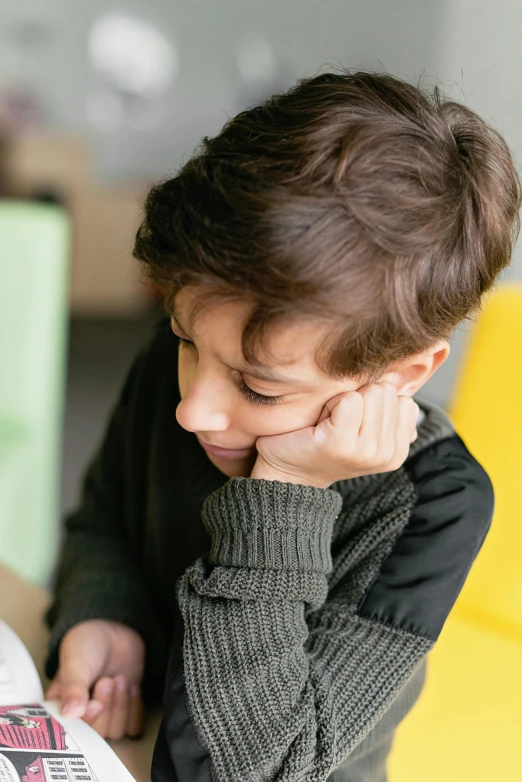 there is a  that has his hand on the book