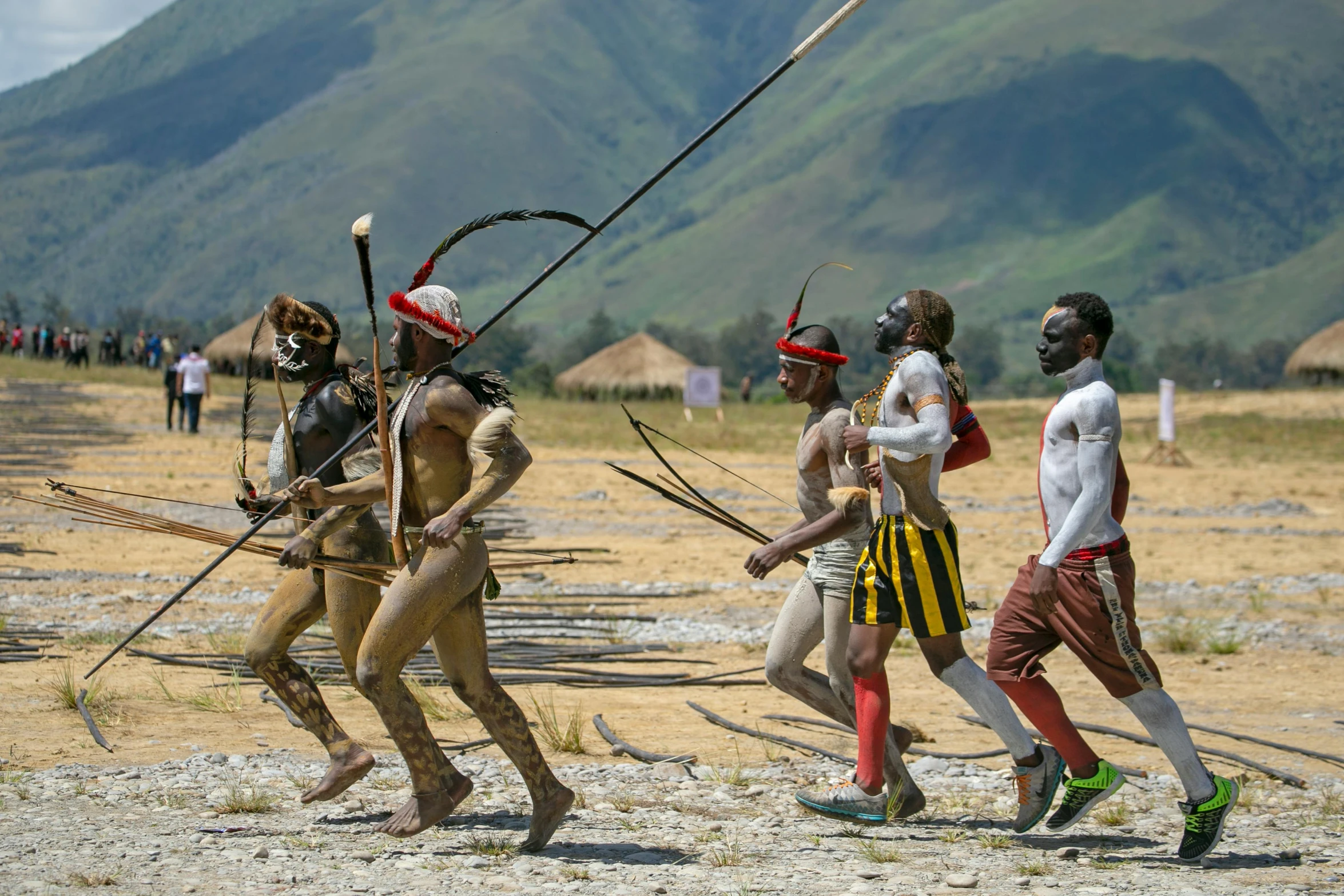 three men with long poles in various body poses