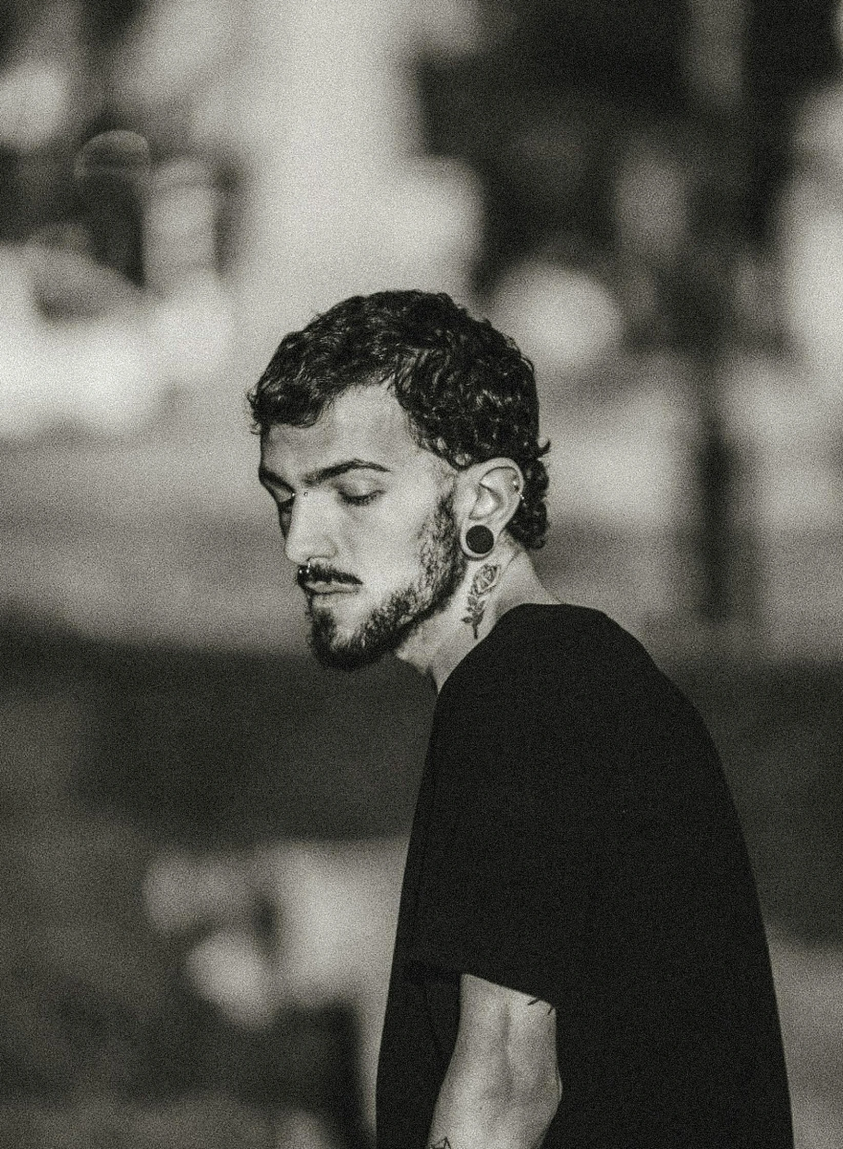 black and white pograph of a man with piercings