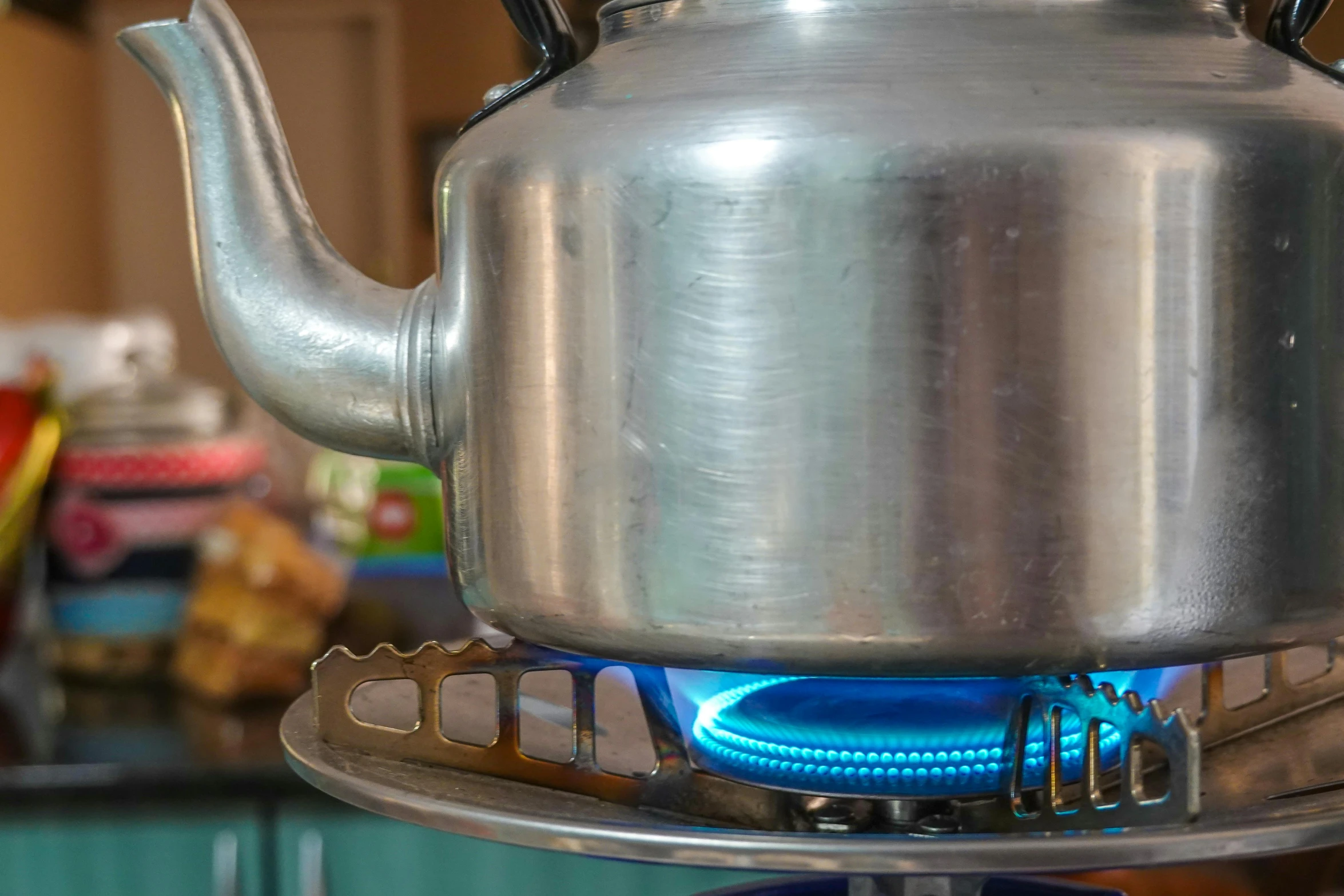 a teapot with flames burning and a cup