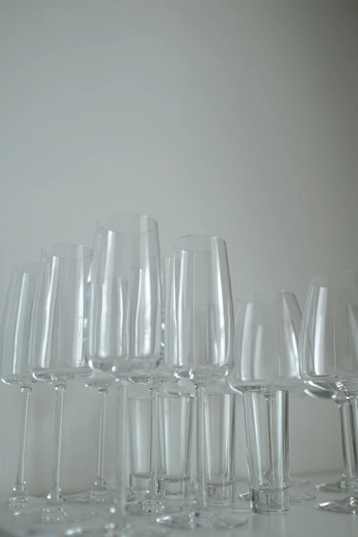 a collection of wine glasses lined up on the counter