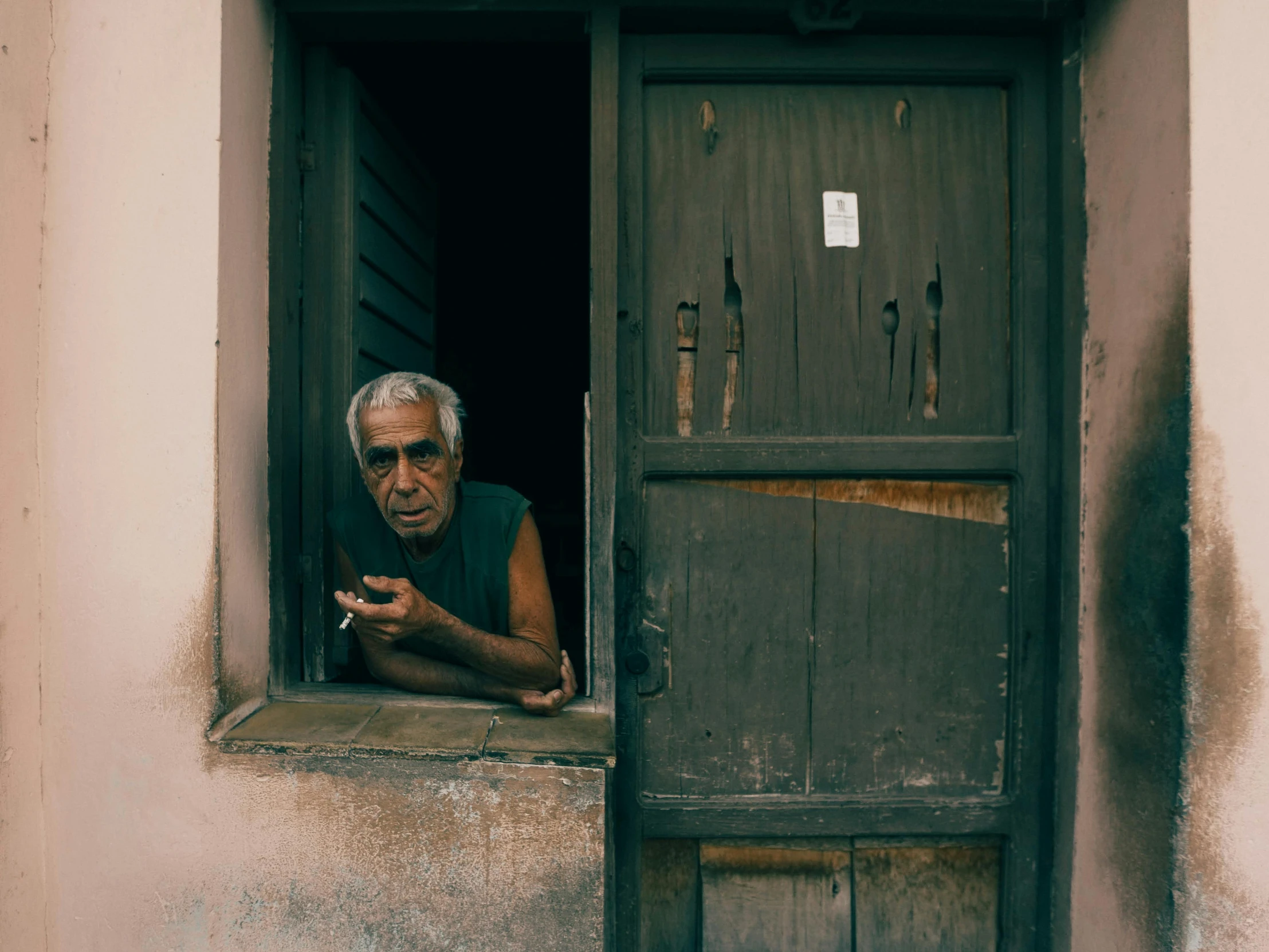 a man who is looking out of a window