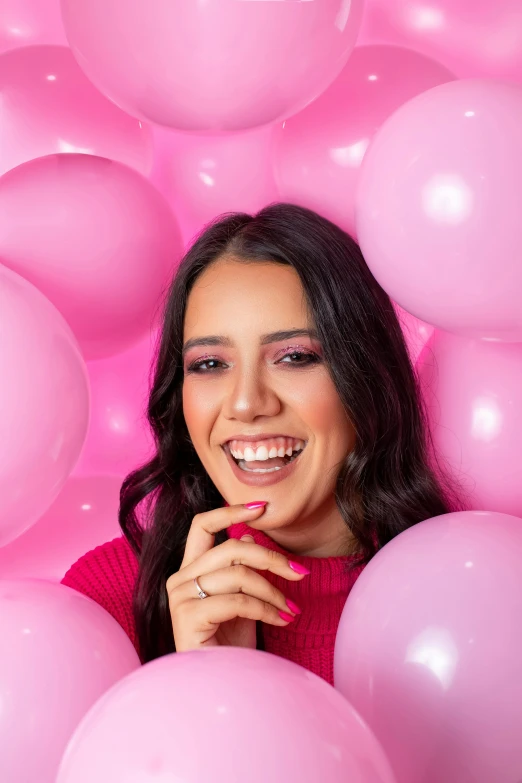 woman surrounded by balloons in pink