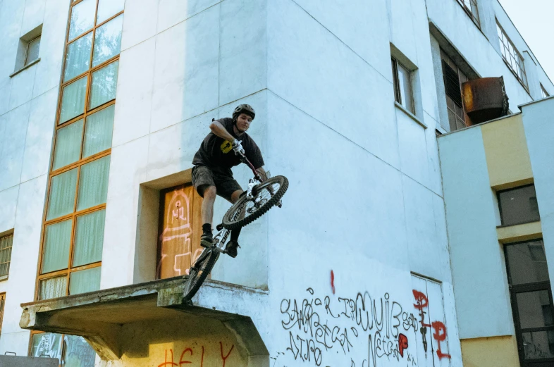 a man jumping with his bike and doing tricks