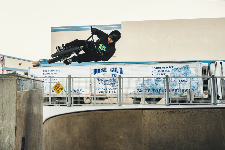 a man flying through the air while riding a snowboard