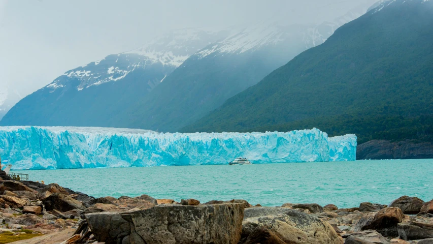 a glacier on the shore of a lake