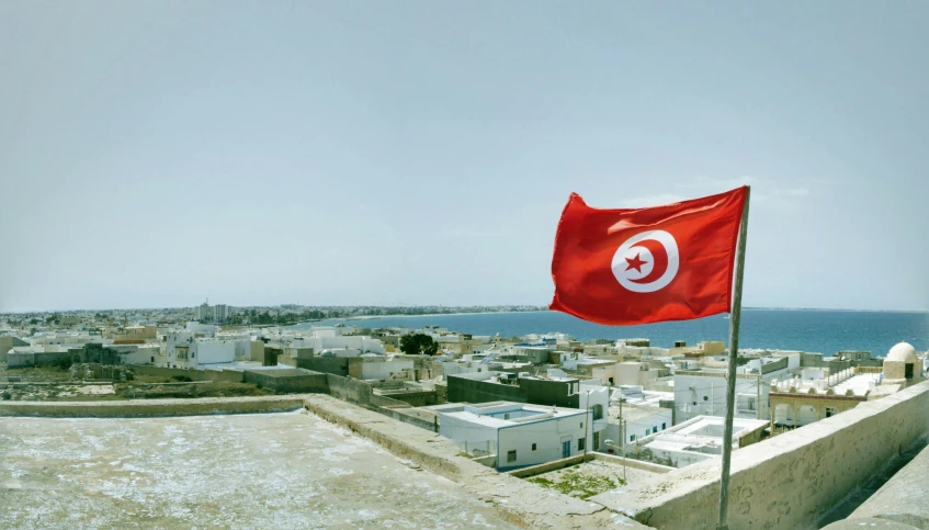 an turkey flag flies on the rooftop of a large city