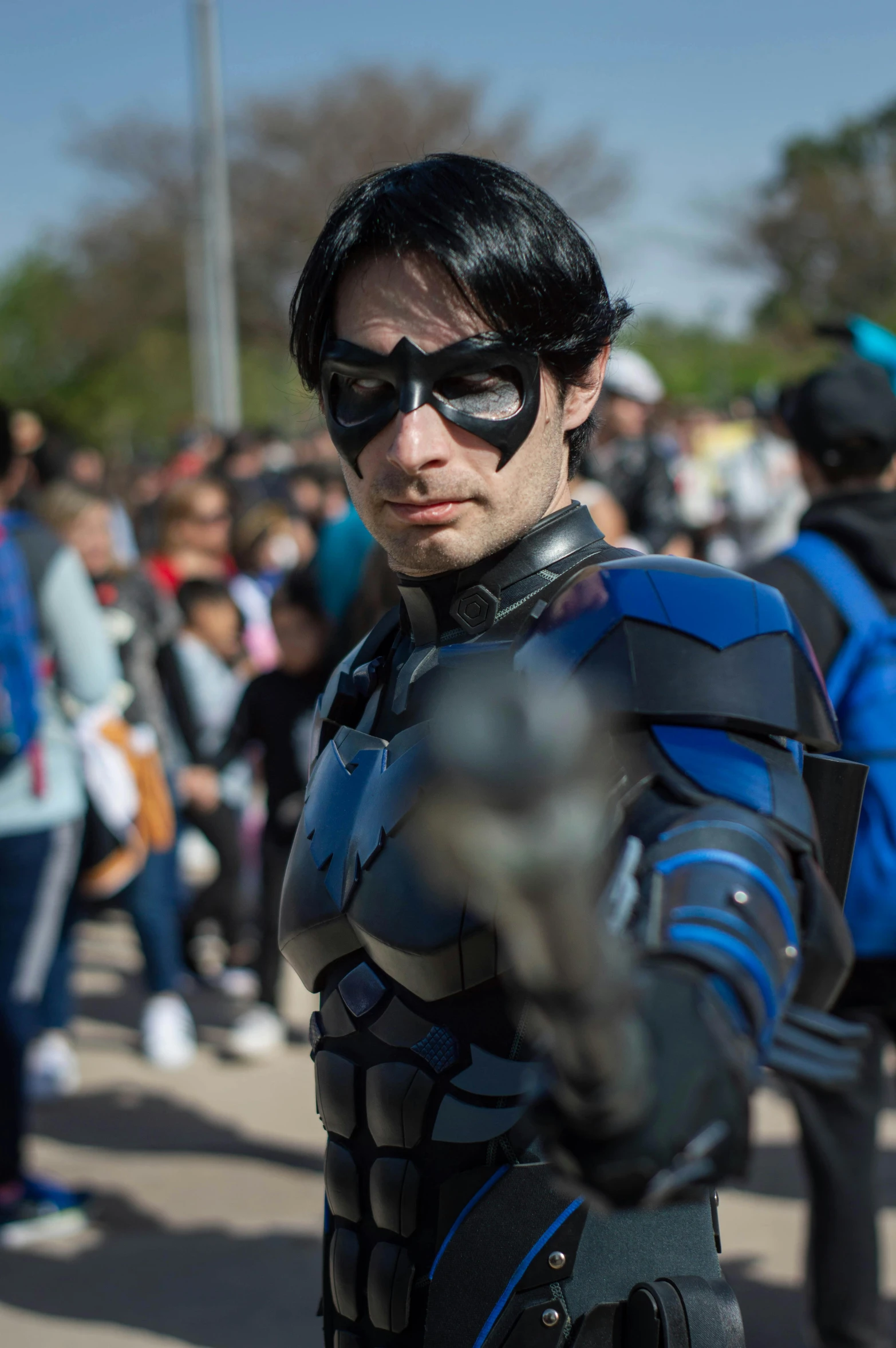 a man dressed in black and blue is looking into the camera