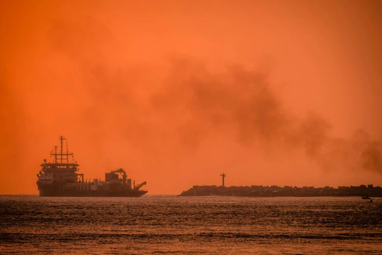 smoke billows out from the top of a ship