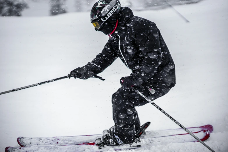 a skier on his snowboard crouching in the snow