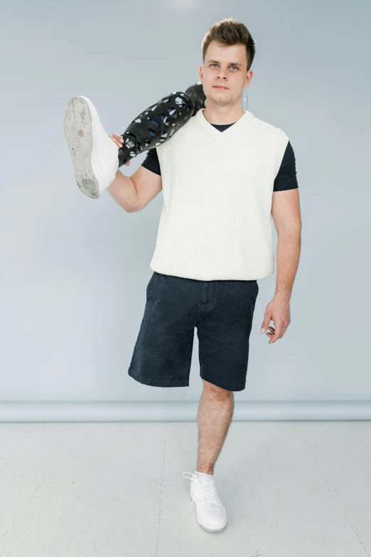 a male in a white shirt holding a glove over his head