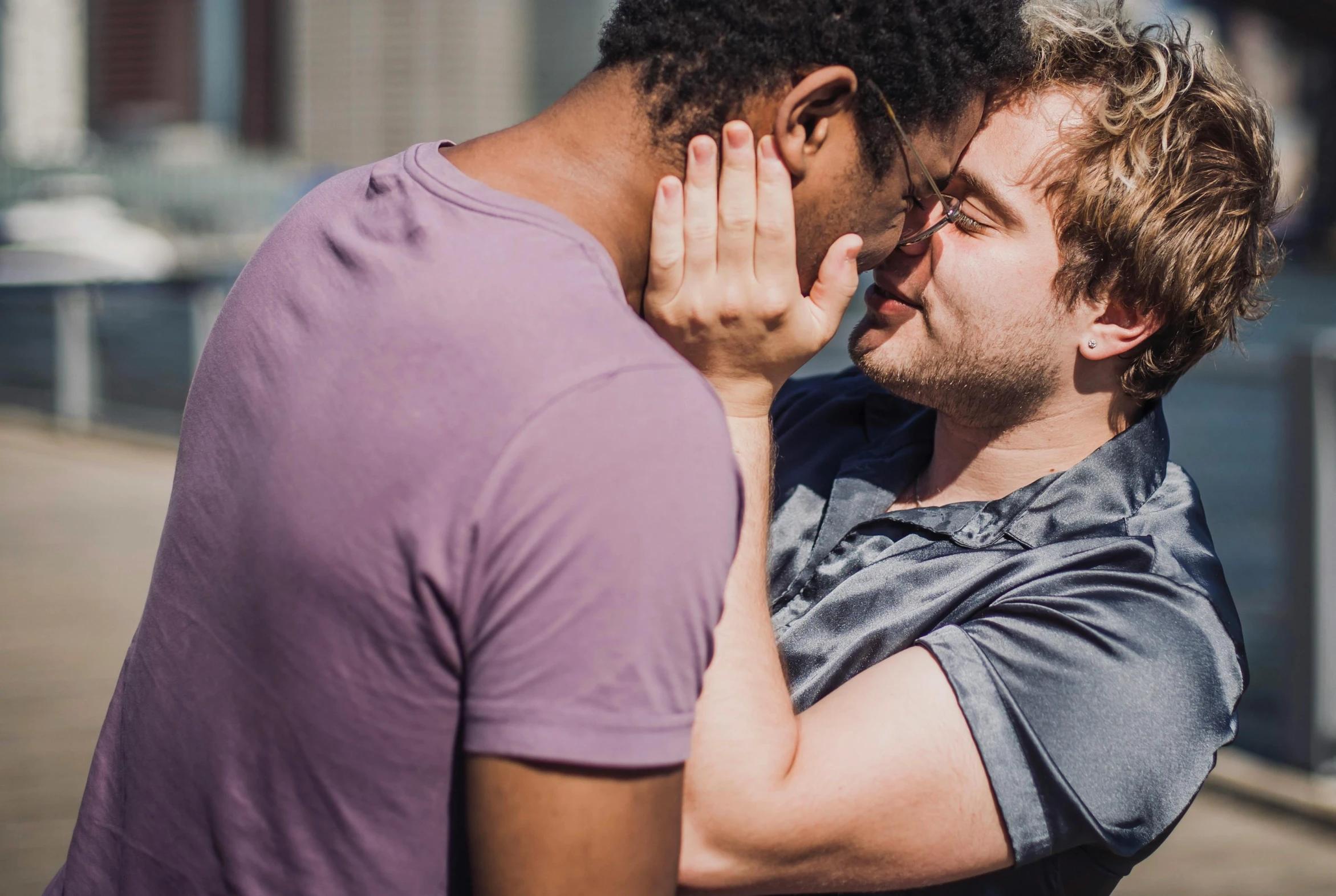 two men are standing together and one man holds his hand over the other's head