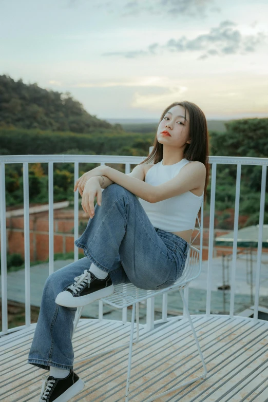 a  sitting on a chair on top of a wooden floor