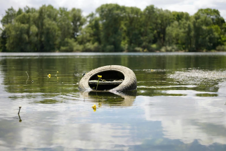 the boat floats on the water near an object