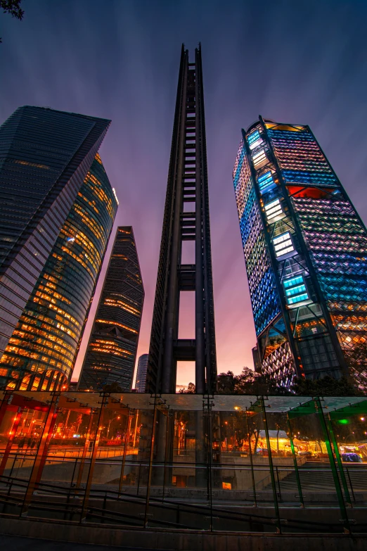 the tall buildings are reflecting in the glass of the building