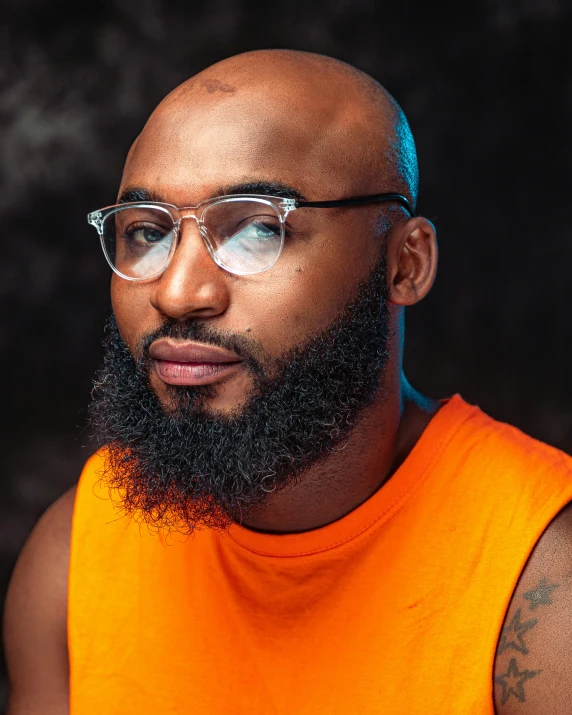 a close up s of a man with a beard wearing glasses